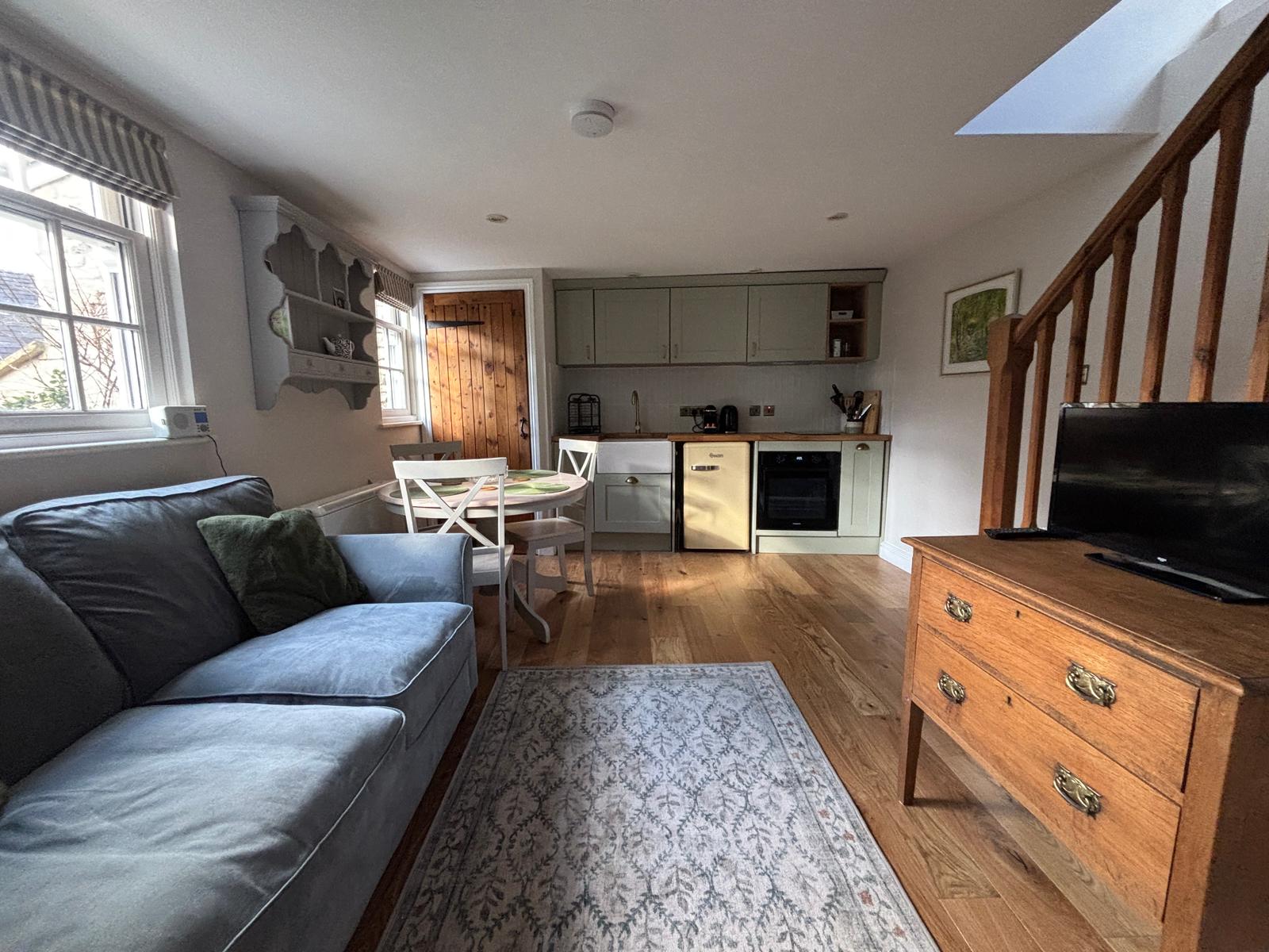 Open plan lounge with kitchen and skylight